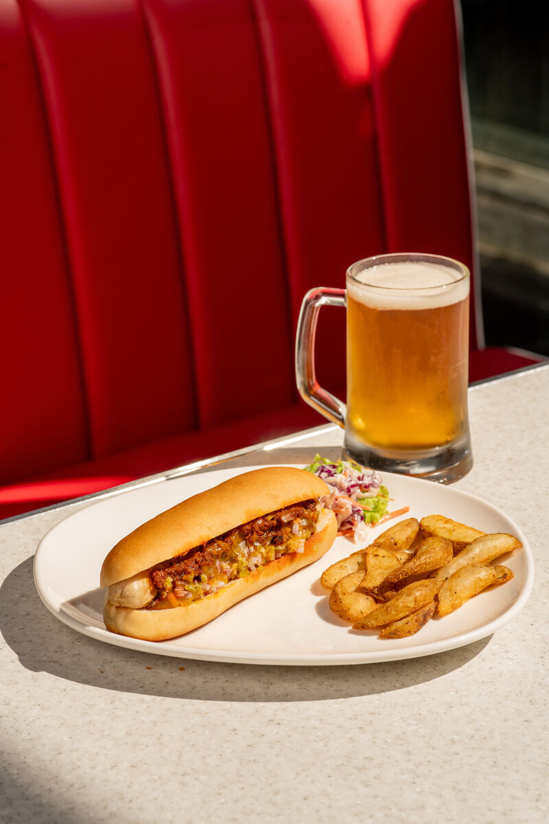 Chilli dog with potato wedges, coleslaw and a mug of beer at the All American Diner Hyderabad
