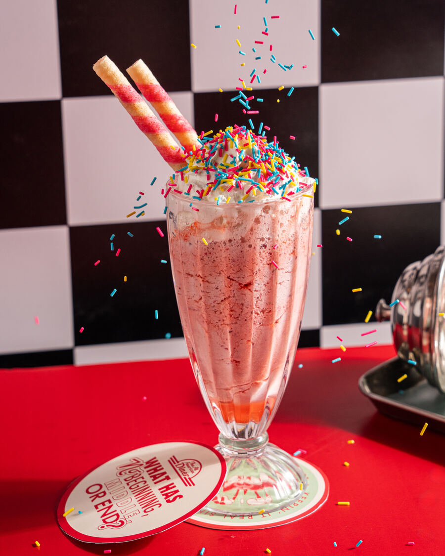Strawberry cream crazy shake topped with sprinkles and wafer rolls at the All American Diner Hyderabad
