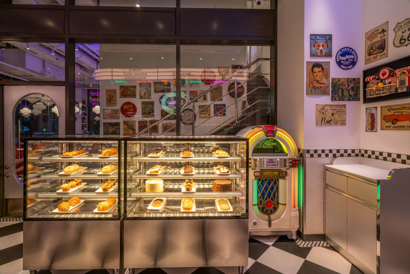 Elvis Wurlitzer jukebox beside a pastry display case at the All American Diner Hyderabad