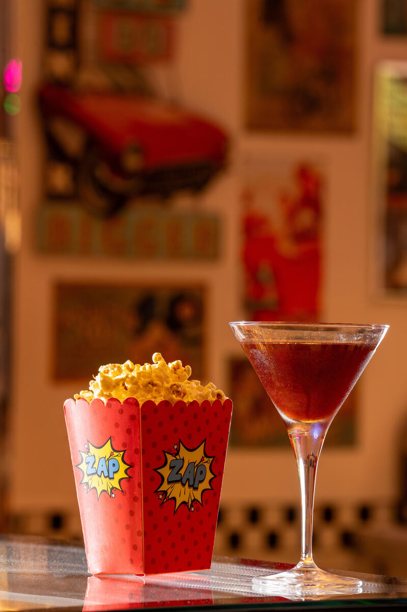 Popcorn Manhattan cocktail served with a box of popcorn at the All American Diner Hyderabad