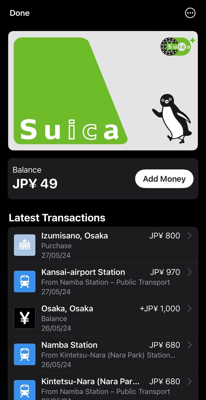 Suica card in Apple Wallet with a ¥49 balance and a transaction list showing train rides between Namba, Kintetsu-Nara and Kansai airport, plus cash top-ups in Osaka
