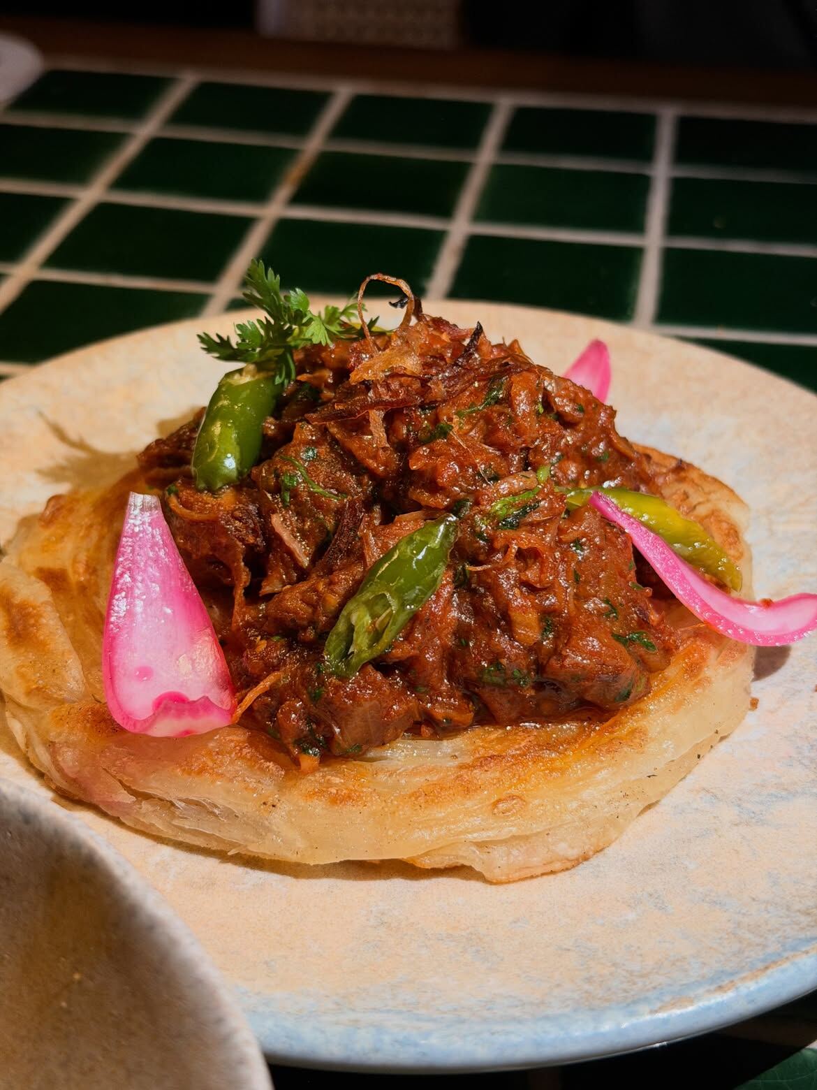 Lamb it Up, slow-cooked lamb on bun parotta, at Bar Stormy, Financial District, Hyderabad