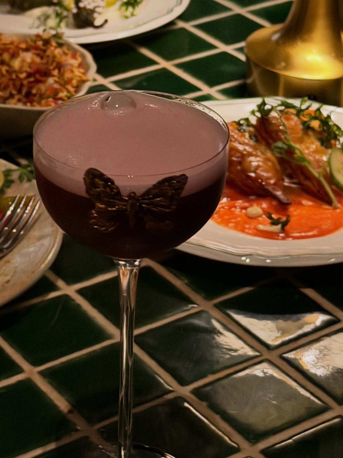 Bar Stormy signature cocktail with a gold butterfly garnish, Financial District, Hyderabad
