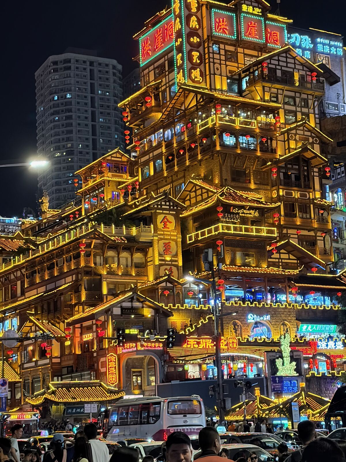 The multi-storey lit-up wooden balconies of Hongya Cave at night