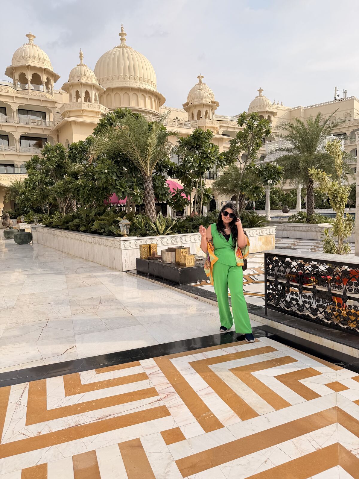 Reema standing in front of the domes of Fairmont Udaipur Palace