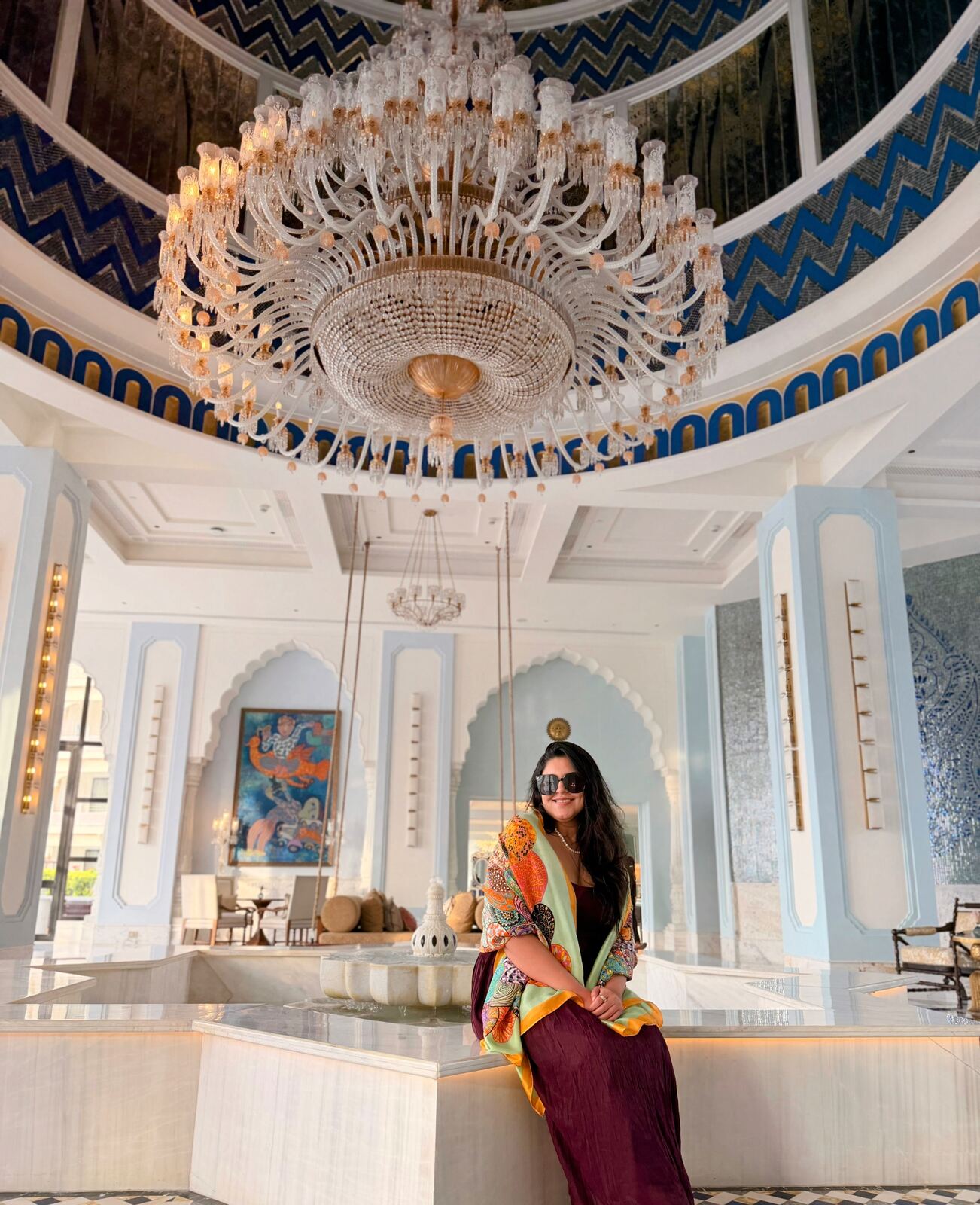 Domed ceiling and crystal chandelier above the central fountain in Fairmont Udaipur Palace lobby