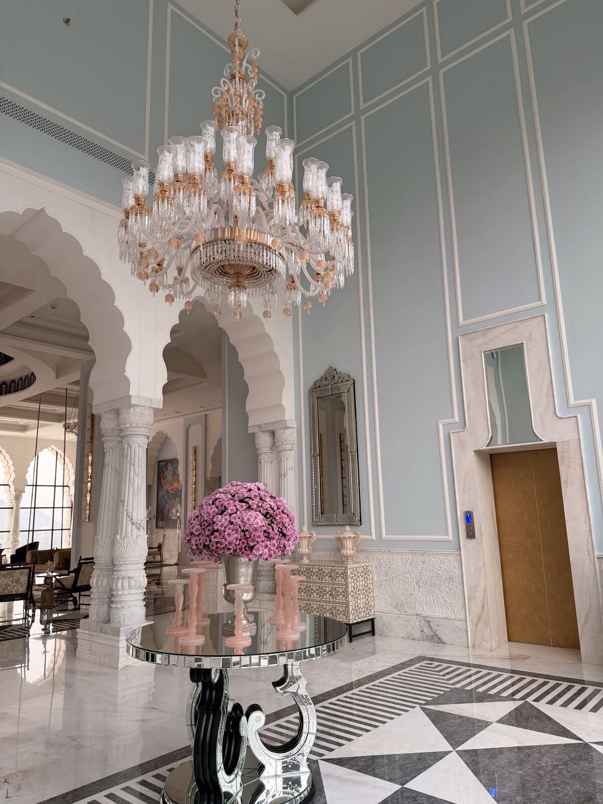Chandelier and elevator lobby with fresh flowers at Fairmont Udaipur Palace