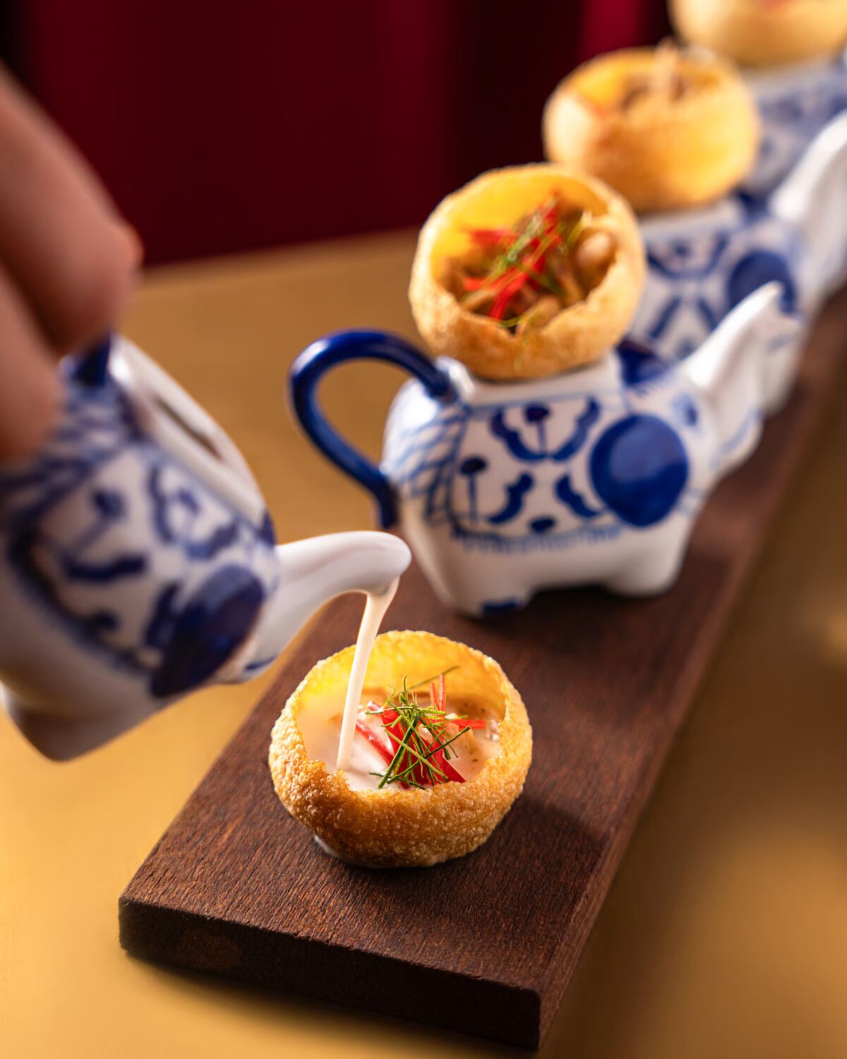 Tom Kha Pani Puri being poured tableside at Gaa Bangkok — Two Michelin Star Indian fusion high tea