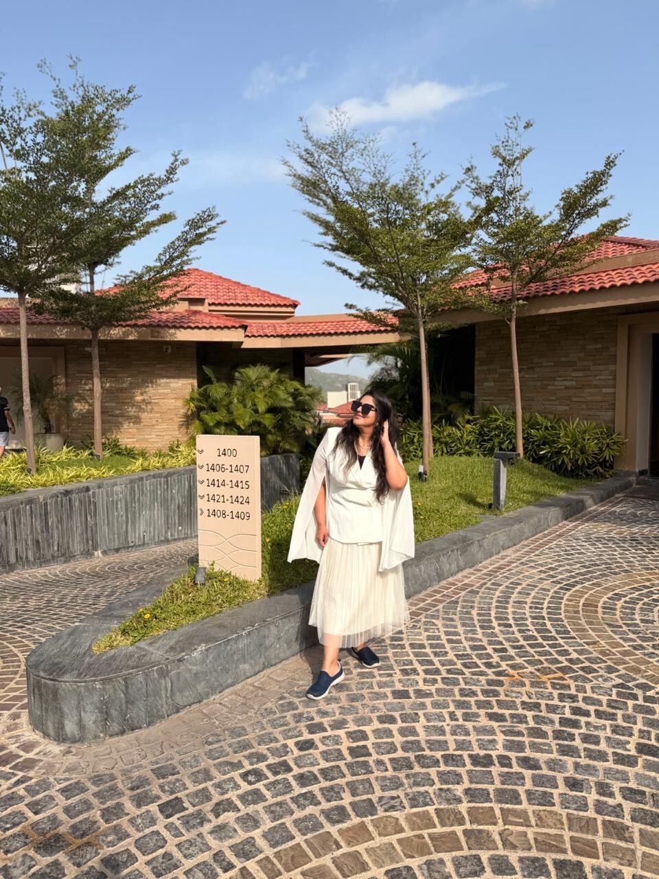 Reema standing on a cobbled path beside a villa at Mementos by ITC Hotels Ekaaya Udaipur