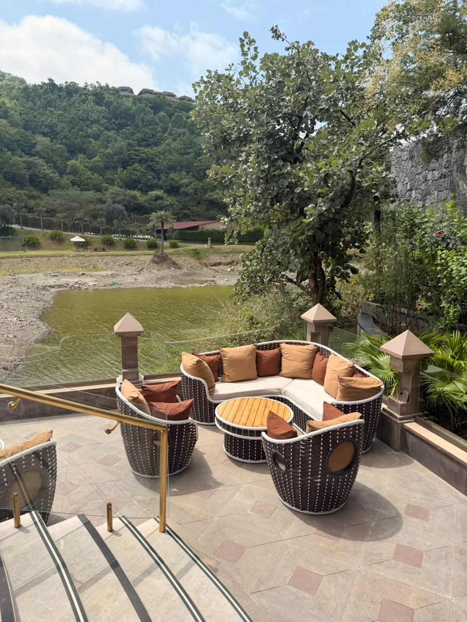 Outdoor sit-out lounge seating overlooking green hills at Mementos Ekaaya Udaipur