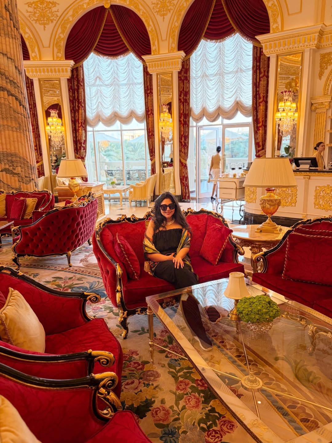 Raffles The Palm Dubai grand palatial lobby with intricate gold detailing and crystal chandeliers