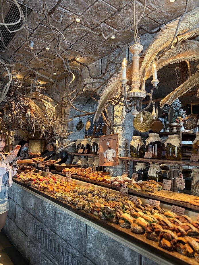 Stone archways and pastry counter inside the Harry Potter-themed Apoli Ita Bakery in Shanghai