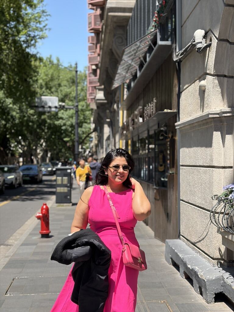 Reema walking down a tree-lined street near Wukang and Anfu Road in Shanghai's Former French Concession