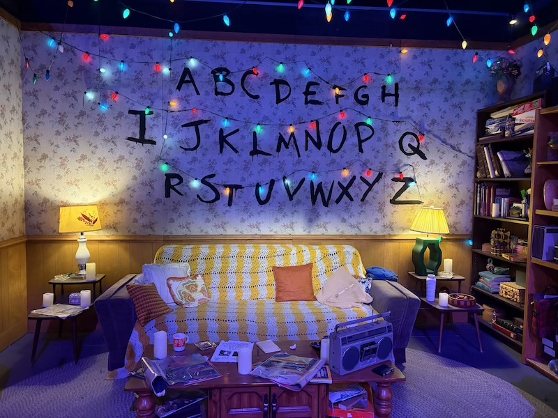 Will Byers' iconic house recreation at Stranger Things Experience with authentic 1980s decor and Christmas lights
